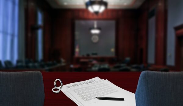 A courtroom table featuring a legal document and a pen, symbolising the process of justice and legal proceedings