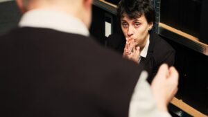 Private detective works on clandestine operation with experienced partner, using witness statements and surveillance materials as evidence. Agents doing teamwork under pressure. Handheld shot