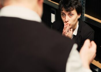 Private detective works on clandestine operation with experienced partner, using witness statements and surveillance materials as evidence. Agents doing teamwork under pressure. Handheld shot