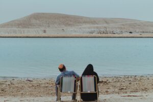 An Old Bahrain couple by the seashore; locate birth parents in Bahrain concept