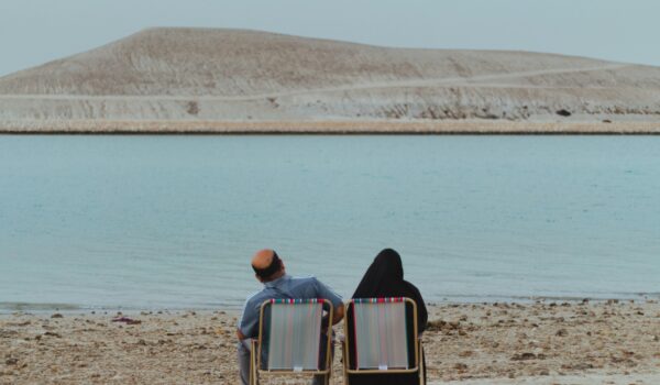 An Old Bahrain couple by the seashore; locate birth parents in Bahrain concept