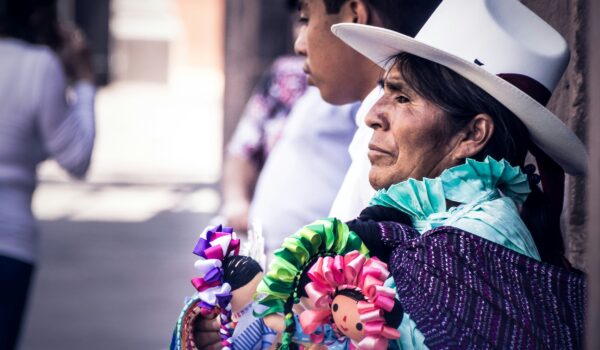 Mexican mother wearing traditional Mexican clothes, locate birth parents in Mexico concept