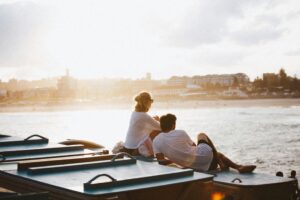 Australian couple sitting by a seawall in Sydney, Australia; locate birth parents in Australia