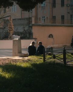 couple sitting by a field of grass; locate birth parents in Croatia concept