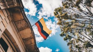 low angle shot of a Colombian flag in a building; skip tracing services in Colombia concept