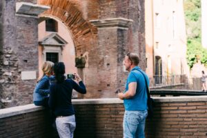 Italian family of three taking pictures in Rome; locate birth parents in Italy concept