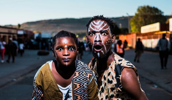 South African father and son wearing traditional face paint; locate birth parents in South Africa