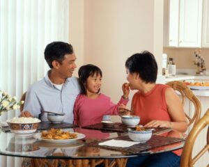 Filipino family eating at a the table; locate birth parents in the Philippines concept