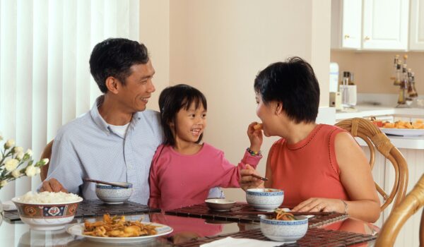 Filipino family eating at a the table; locate birth parents in the Philippines concept