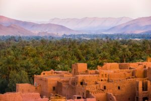 overview of Moroccan village, forest, and mountains; skip tracing services in Morocco concept