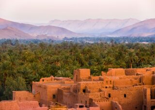 overview of Moroccan village, forest, and mountains; skip tracing services in Morocco concept