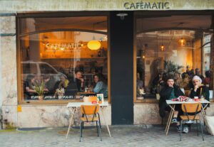 front of a cafe showing couples dining; locate birth parents in Belgium concept