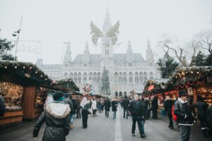 people waking in an outdoor market in Vienna, Austria, locate birth parents in Austria concept