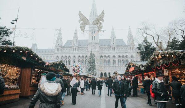 people waking in an outdoor market in Vienna, Austria, locate birth parents in Austria concept