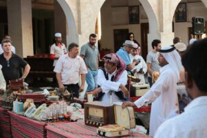 market in daytime with people selling in Doha, Qatar; locate birth parents in Qatar concept