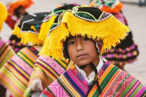 Peruvian child wearing traditional wear; locate birth parents in Peru concept