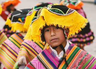 Peruvian child wearing traditional wear; locate birth parents in Peru concept