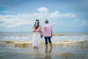 Panamanian couple in the seashore looking at the sea; locate birth parents in Panama concept