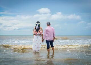 Panamanian couple in the seashore looking at the sea; locate birth parents in Panama concept