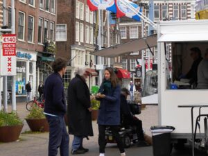 Dutch family standing near a food truck; locate birth parents in Netherlands concept