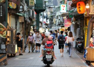 father and daughter riding a scooter in the streets of Taiwan; locate birth parents in Taiwan concept