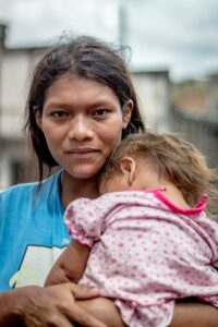 portrait of a Paraguayan mother with her child; locate birth parents in Paraguay concept