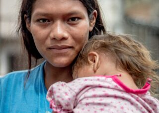 portrait of a Paraguayan mother with her child; locate birth parents in Paraguay concept