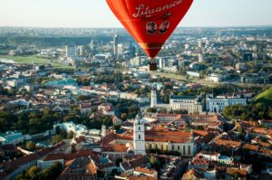 hot air balloon flying over Vilnius Old Town, Vilnius, Lithuania; skip tracing services in Lithuania concept