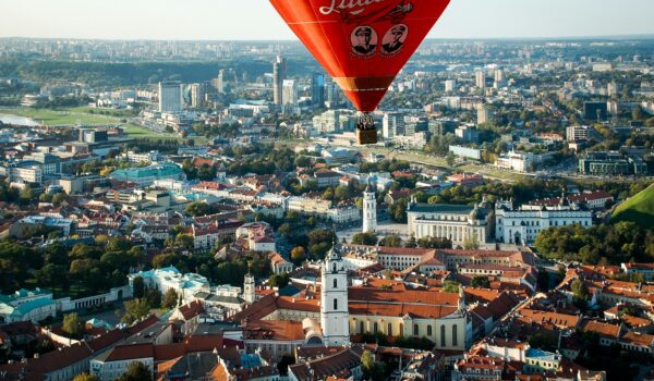 hot air balloon flying over Vilnius Old Town, Vilnius, Lithuania; skip tracing services in Lithuania concept