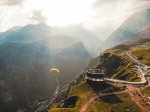 Georgian mountains with a paraglider; skip tracing services in Georgia concept