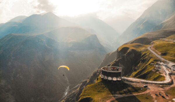 Georgian mountains with a paraglider; skip tracing services in Georgia concept