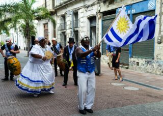 Afro-Uruguayan celebrating in the streets of Montevideo, Uruguay; locate birth parents in Uruguay concept