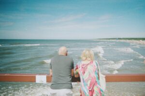 old couple looking at the sea in Palanga City Municipality, Lithuania; locate birth parents in Lithuania concept