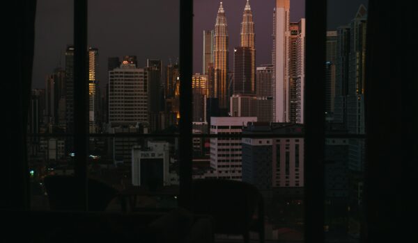 Petronas Towers in Malaysia shot from a window; skip tracing services in Malaysia concept