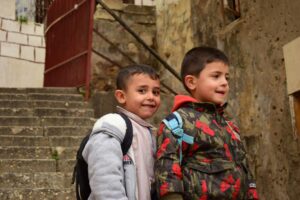 portrait of two Lebanese boys standing on the stairs; locate birth parents in Lebanon concept