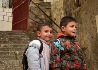 portrait of two Lebanese boys standing on the stairs; locate birth parents in Lebanon concept