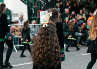 Irish girls in a parade during St. Patrick's Day; locate birth parents in Ireland concept